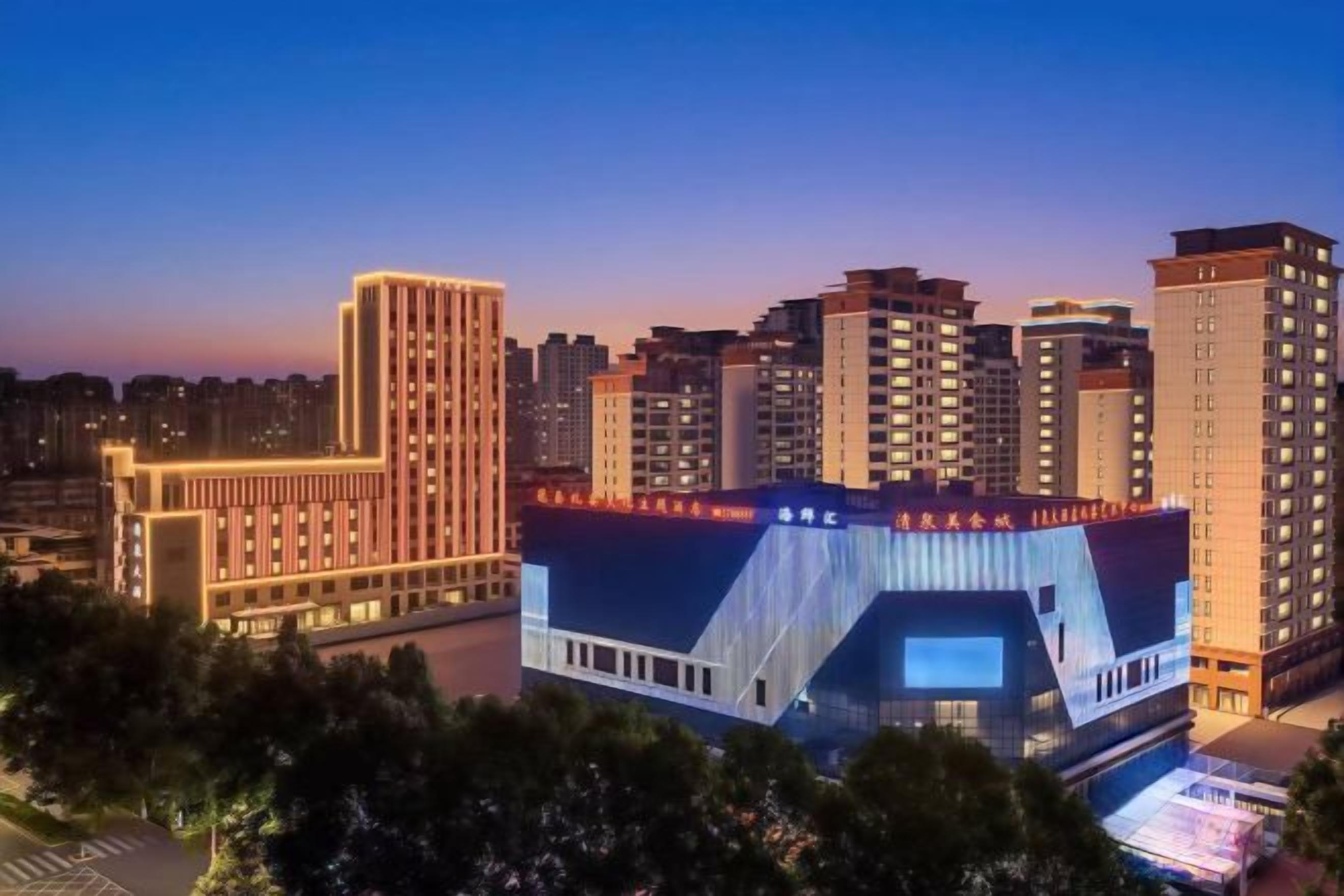 A cityscape with high-rise buildings, one with a distinctive curved facade.
