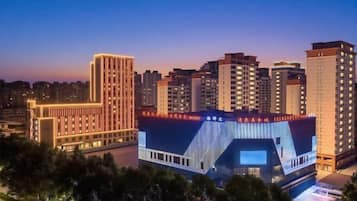 A cityscape with high-rise buildings, one with a distinctive curved facade.
