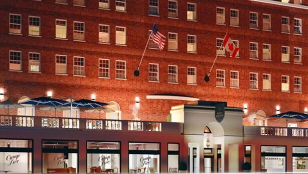 A multi-story hotel with a prominent sign reading "HOTEL SARANAC".