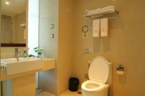 A bathroom with a sink, mirror, toilet, and towel rack. - Dadong Haiminghe Inn (Sanya)