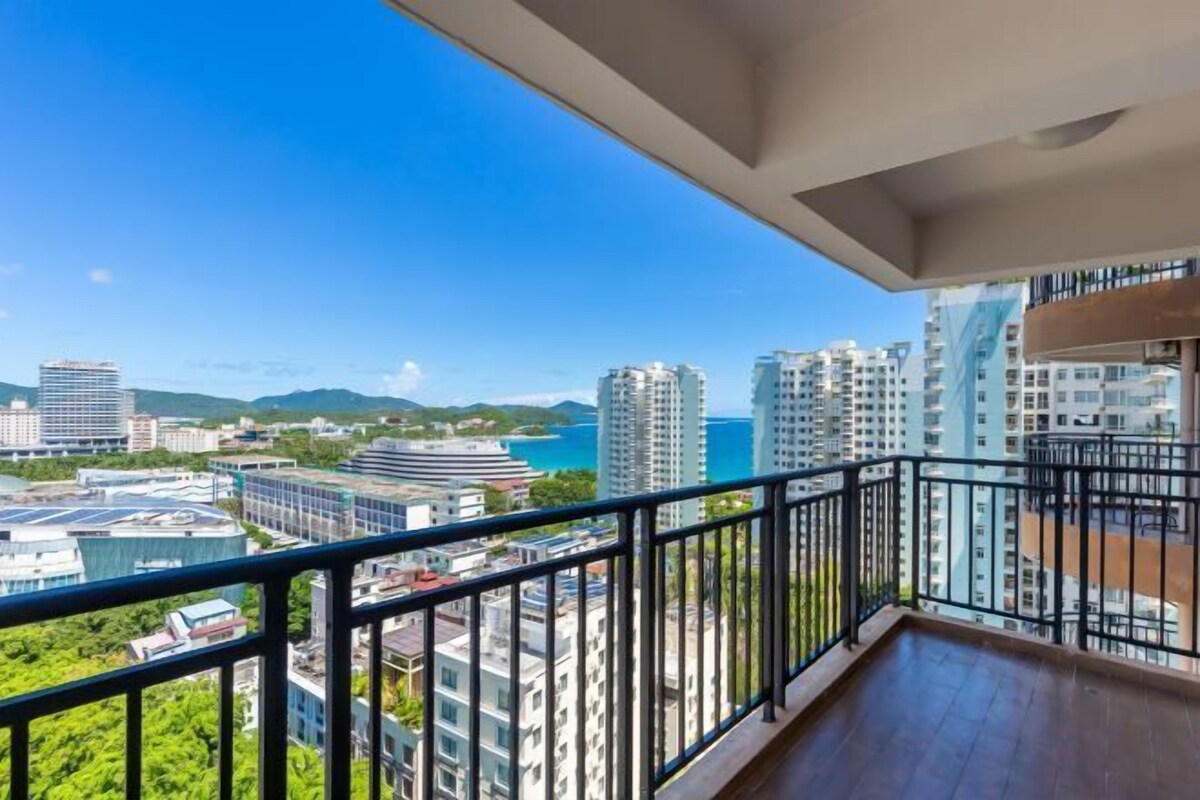 A balcony with a view of a cityscape and a body of water.