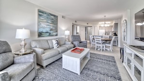 A modern living room with a grey sofa, a white coffee table, and a patterned rug. - Gulf Front 2/2 Flash sale 3rd floor unit PPE6310 (Gulf Shores)