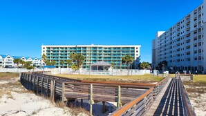 A beachfront hotel with multiple balconies, a pool area, and a wooden boardwalk. - Gulf Front 2/2 Flash sale 3rd floor unit PPE6310 (Gulf Shores)