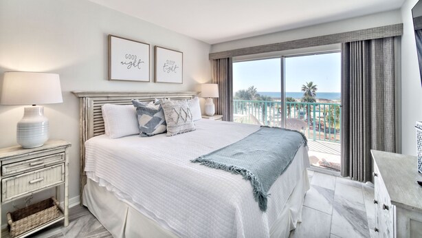 A bedroom with a bed, bedside tables, a nightstand, a view of the ocean, and a balcony. - Gulf Front 2/2 Flash sale 3rd floor unit PPE6310 (Gulf Shores)