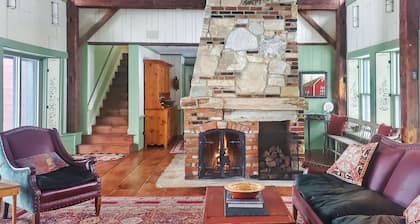 The Old Orchard Home surrounded by a small apple orchard, large meadows, and a private pond