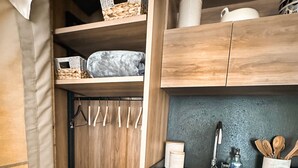 A compact kitchen with wooden cabinets, a sink, and a countertop. - Outdoorsy Bayfield (Bayfield)
