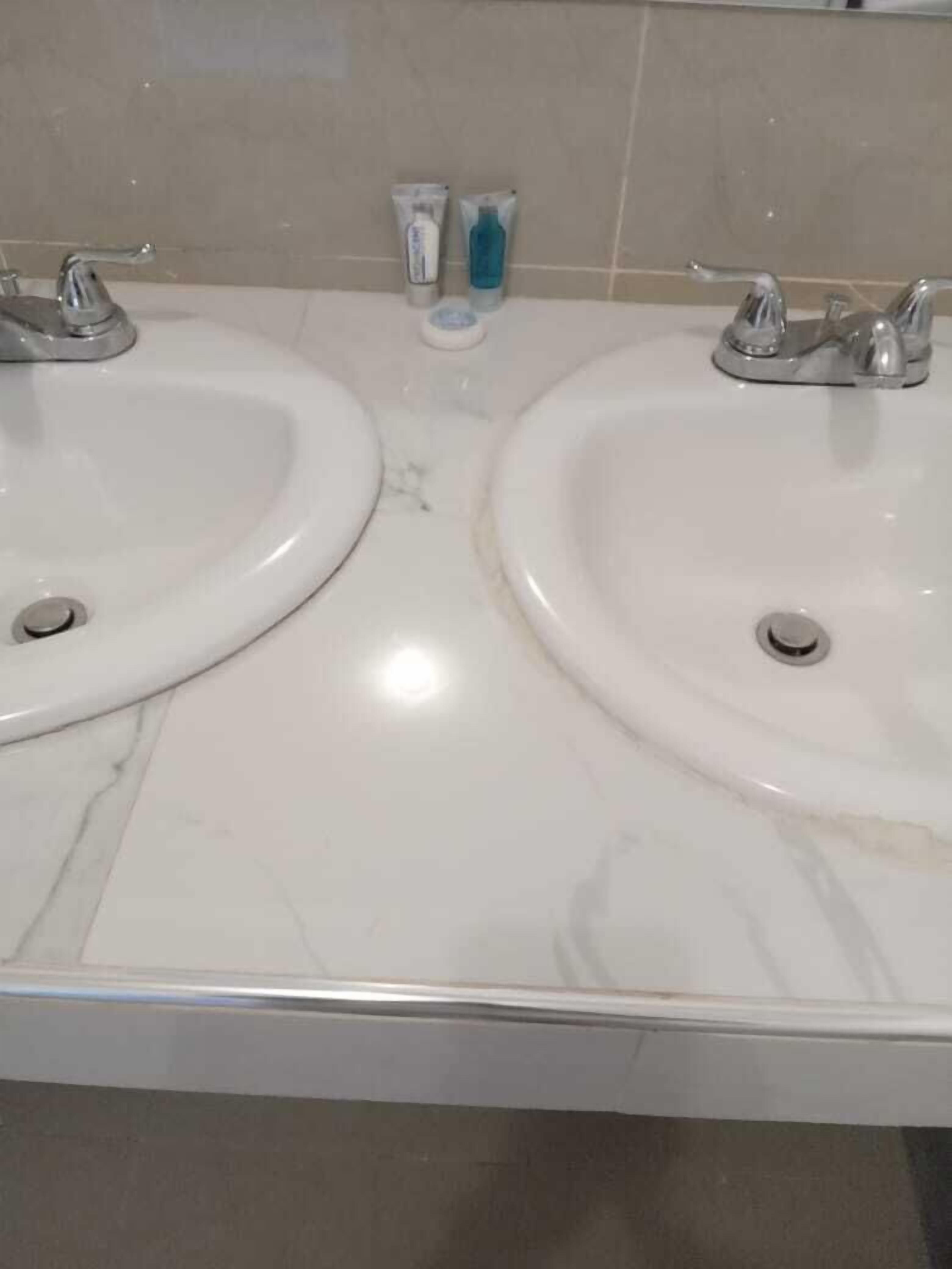 A bathroom with two sinks and a mirror.