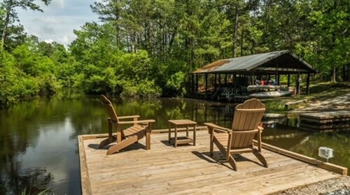 Secluded cozy tiny cabin on the water with fire pit and private dock