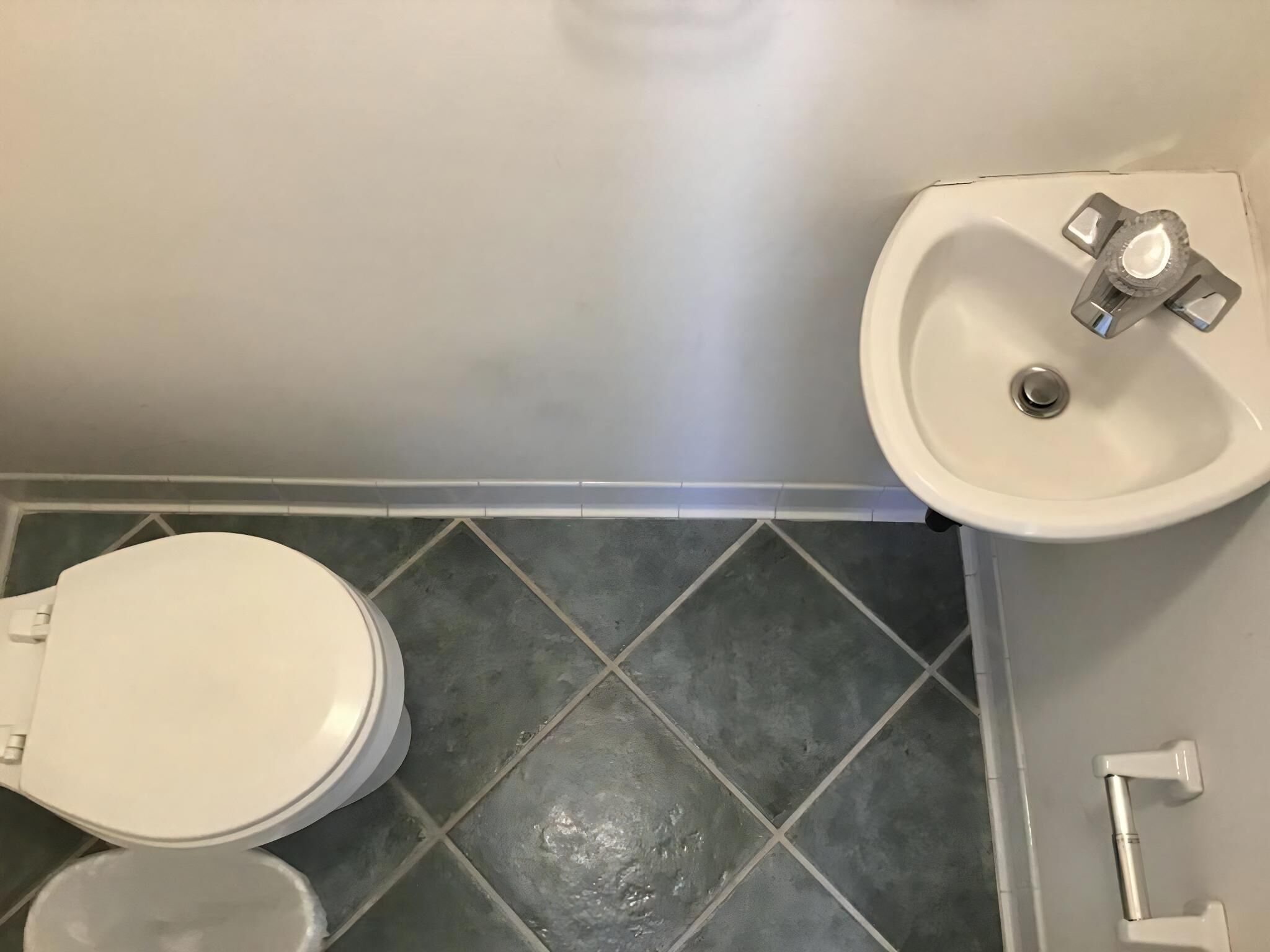 A bathroom with a toilet, bidet, and sink.