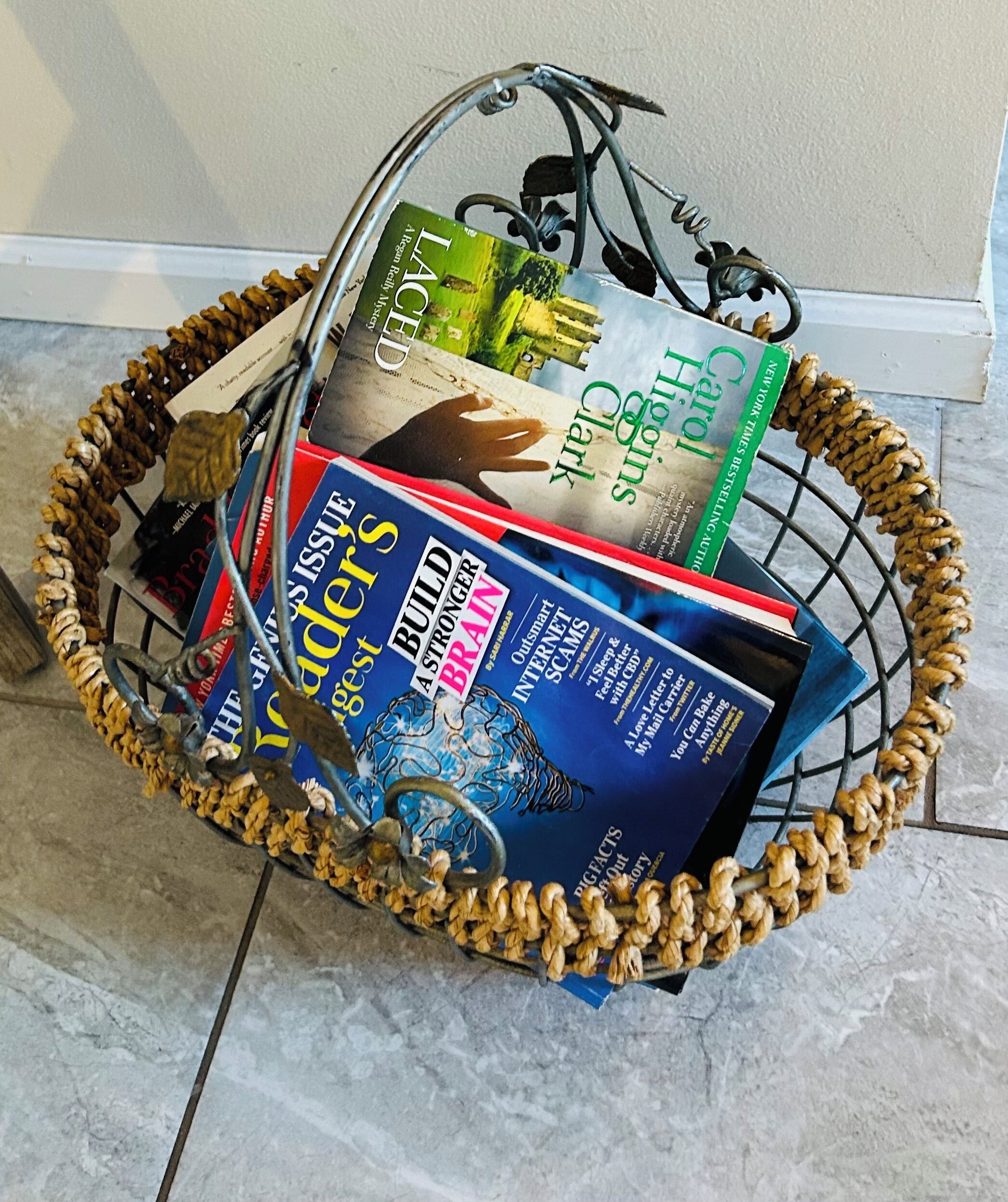 A wicker basket filled with various books.