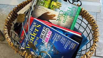 A wicker basket filled with various books.