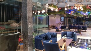 A modern lounge area with seating and a coffee bar. - BlueTel Re'sidence Bangkok IMPACT  (Pak Kret)