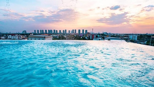 A waterfront view with a city skyline in the background. - BlueTel Re'sidence Bangkok IMPACT  (Pak Kret)