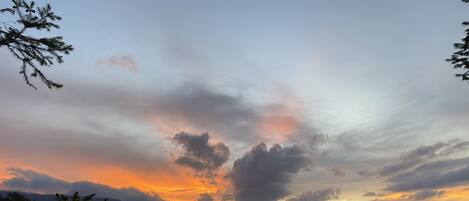 A mountainous landscape with a sunset.