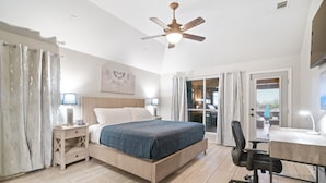 A bedroom with a bed, bedside tables, a desk, a chair, and a ceiling fan. - Unique heated pool & spa outdoor kitchen, game room near DFW  sleeps 10-12 (Lewisville)