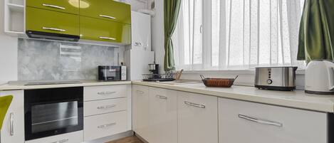 Comfort Apartment | Private kitchen | Full-sized fridge, microwave, oven, coffee/tea maker