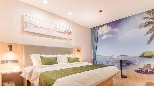 A modern hotel room with a large bed, a nightstand, a wall-mounted control panel, and a mural of a beach scene. - Greentree Inn Hefei Binhu Century City Binhu Hospital (Hefei)