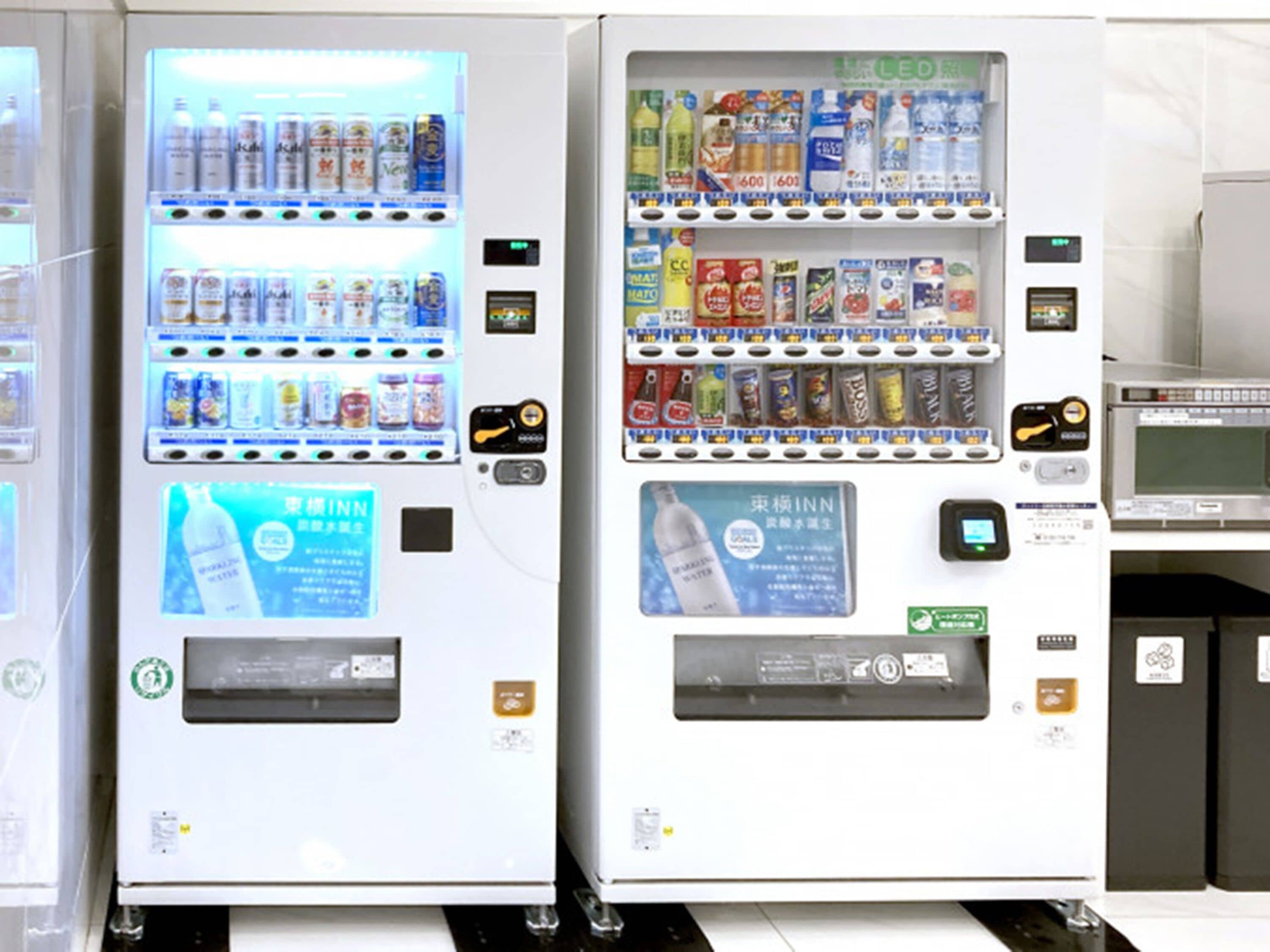 Two vending machines with various beverages and snacks.