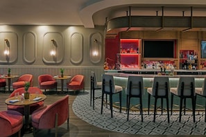 A bar area with a curved counter, red and black chairs, and a patterned floor. - The Perfect Place to Stay! Close to Miami Art Museum, Pet Friendly, Free Shuttle (Miami)