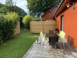 Enjoy dining or socializing on the patio with a wooden deck and table.