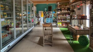 Un magasin doté de vitrines en verre, d’étagères en bois et d’une allée centrale.