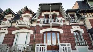 A two-story brick building with a central entrance, white railings, and a small balcony. - Les Ramiers - Criel SUR MER (CRIEL SUR MER)