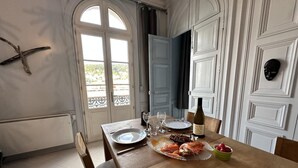 A dining table set with plates, glasses, a bottle, and seafood. - Norwegian Stern - Fecamp (FECAMP)