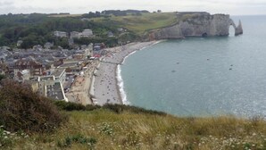 A coastal town with a prominent cliff and beach.