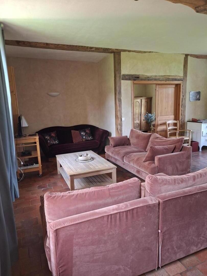 A living room with a sofa set, a coffee table, and a wooden cabinet.
