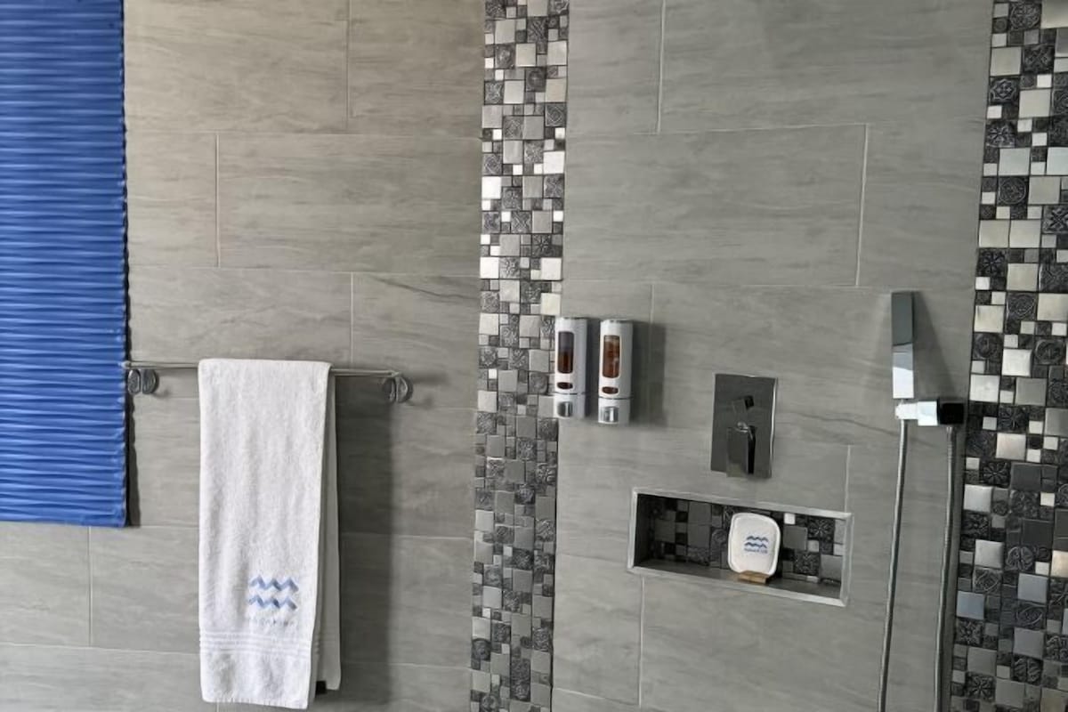 Bathroom | Rainfall showerhead, hair dryer, bathrobes, towels