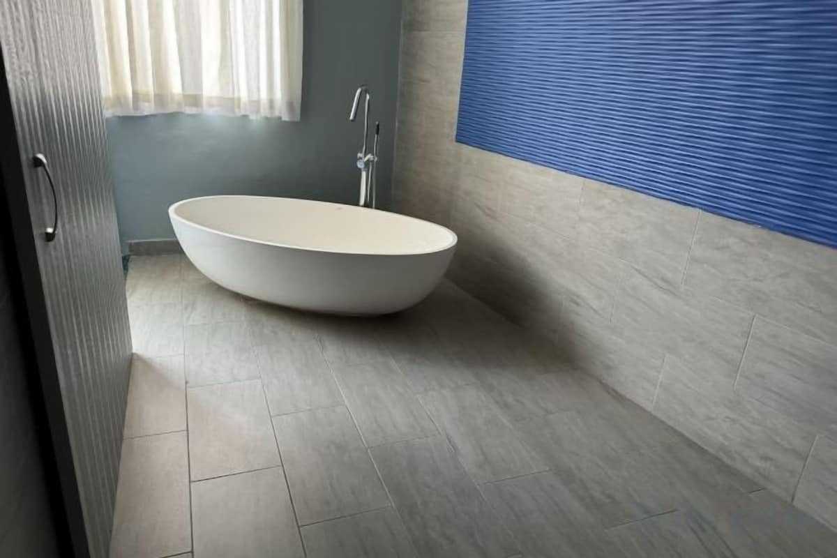 Bathroom | Rainfall showerhead, hair dryer, bathrobes, towels