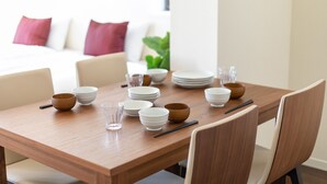 A dining table set with bowls, plates, and chopsticks. - Oyado Nishishichijo (Kyoto)