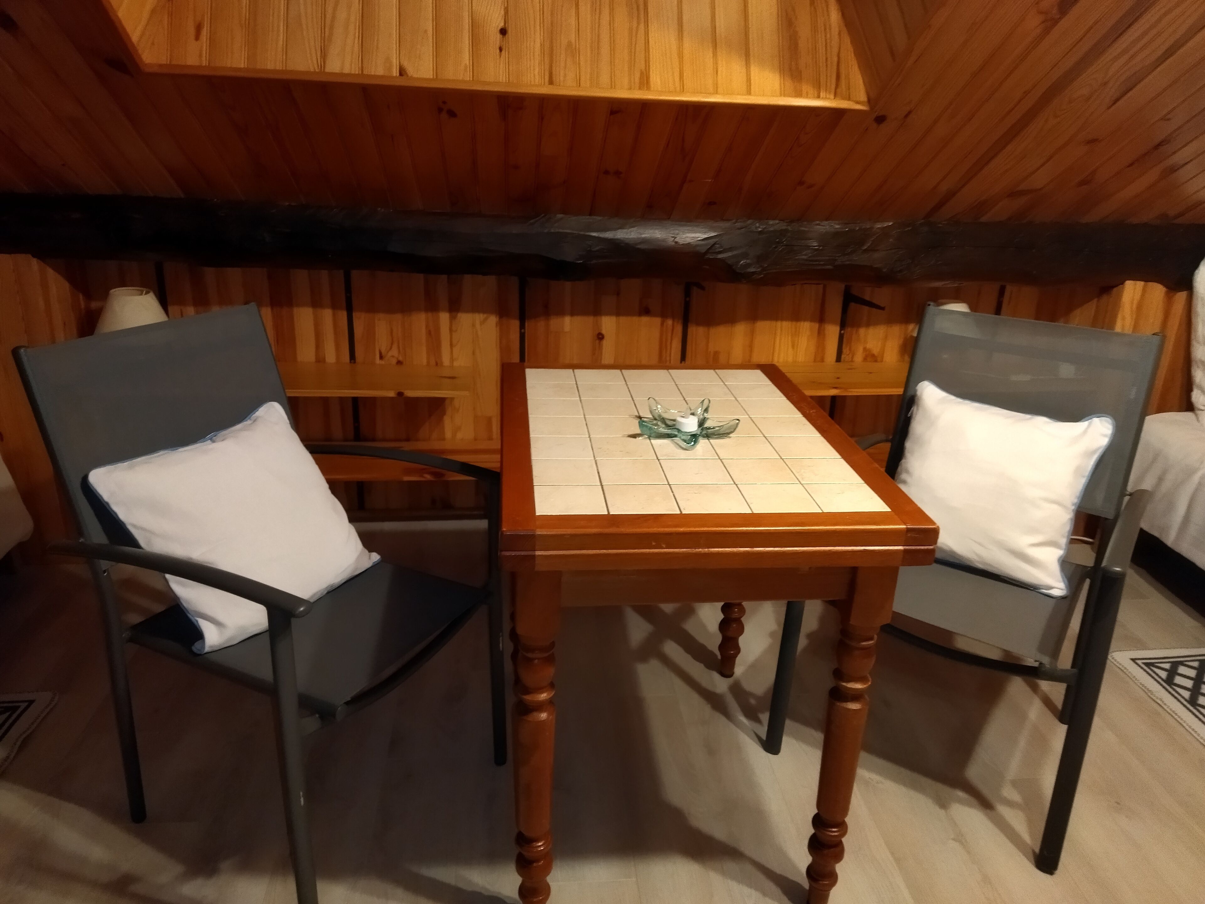 A cozy room with wooden walls and a wooden table with chairs.
