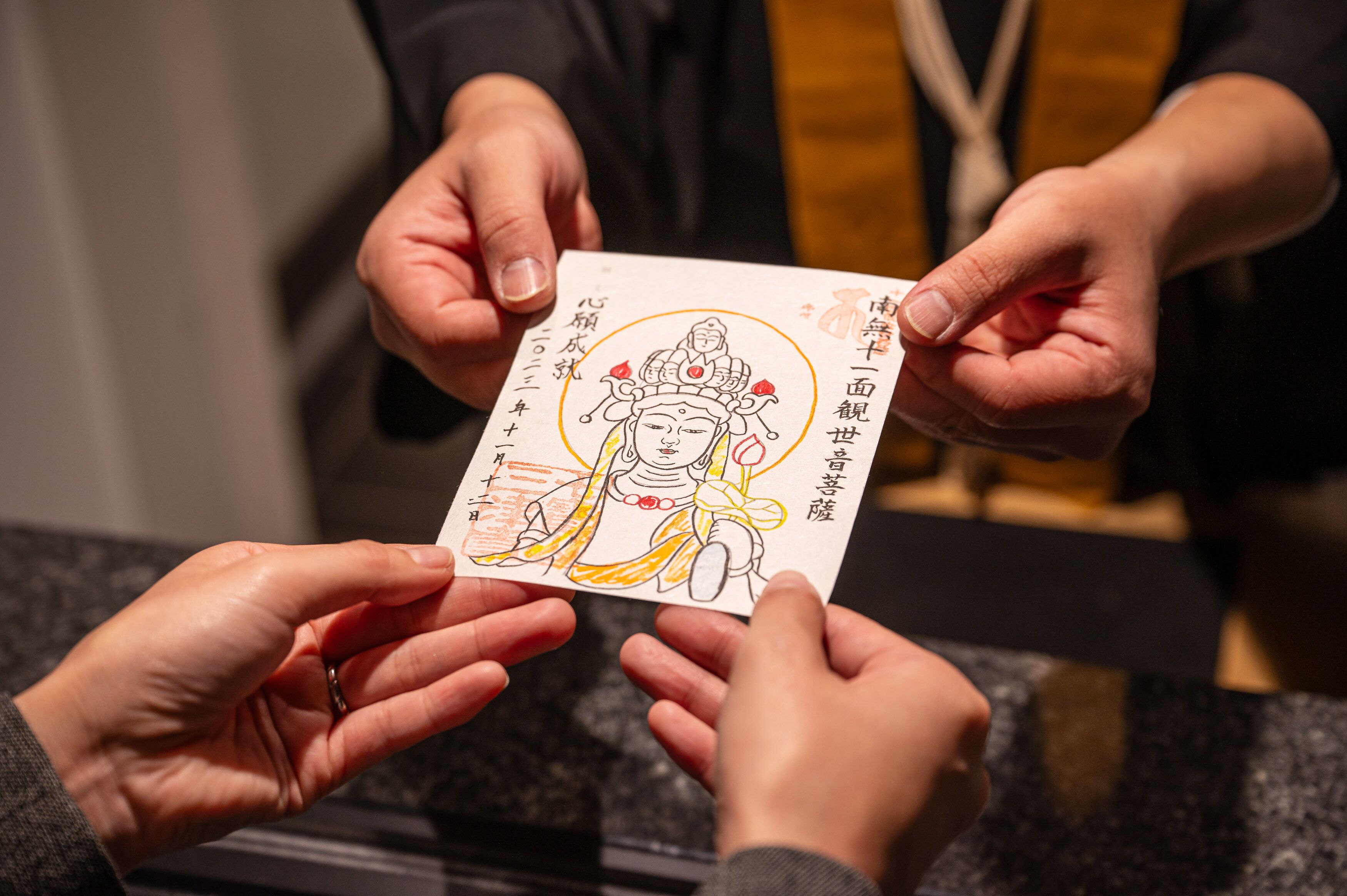 A person holding a card with a drawing and text.