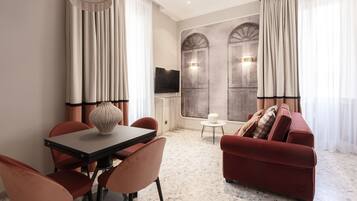 Deluxe appartement | Woonruimte | Een 48-inch flatscreentelevisie met digitale zenders en een televisie