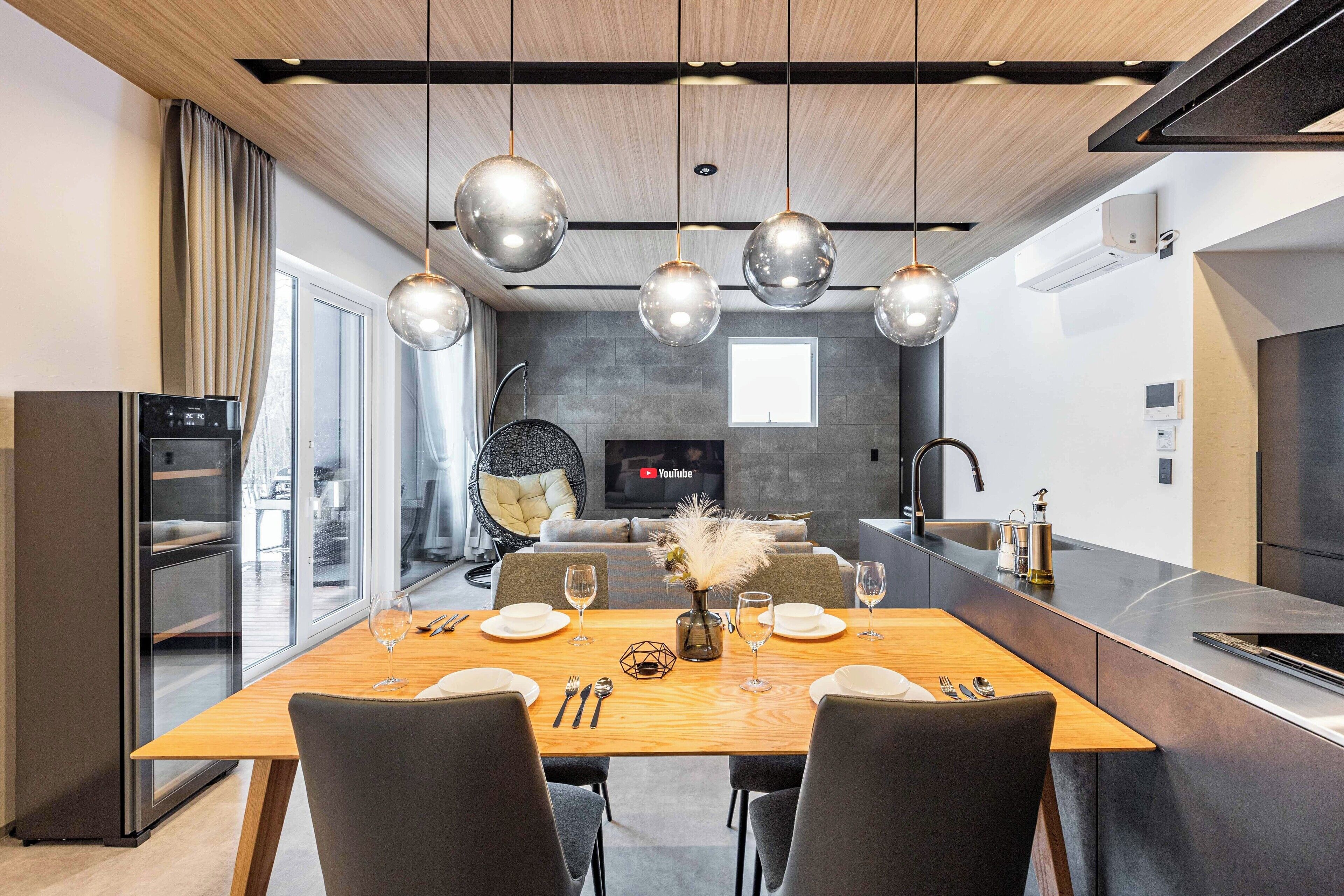 A modern kitchen with a dining area.