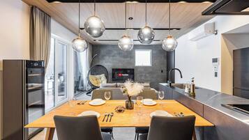 A modern kitchen with a dining area.
