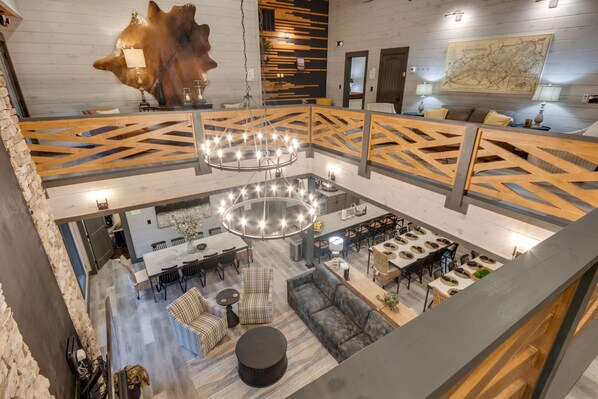A spacious, multi-level hotel lobby with a central open area, seating arrangements, and a large map on the wall.