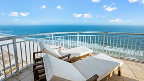 A balcony with two sun loungers and a view of the ocean. - NEW RENTAL-Oceania 13-Luxury 4000 SQ FT Gulf Front Condo-Signature Properties (Gulf Shores)