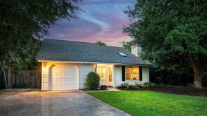 A single-story house with a garage, a front porch, and a well-maintained lawn. - Family & Pet Friendly Home in Quiet Neighborhood - Close to Beaches & Downtown! (Mount Pleasant)