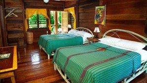 A wooden cabin room with two beds, a ceiling fan, and a window with curtains. - Itza Resort (Lighthouse Reef)