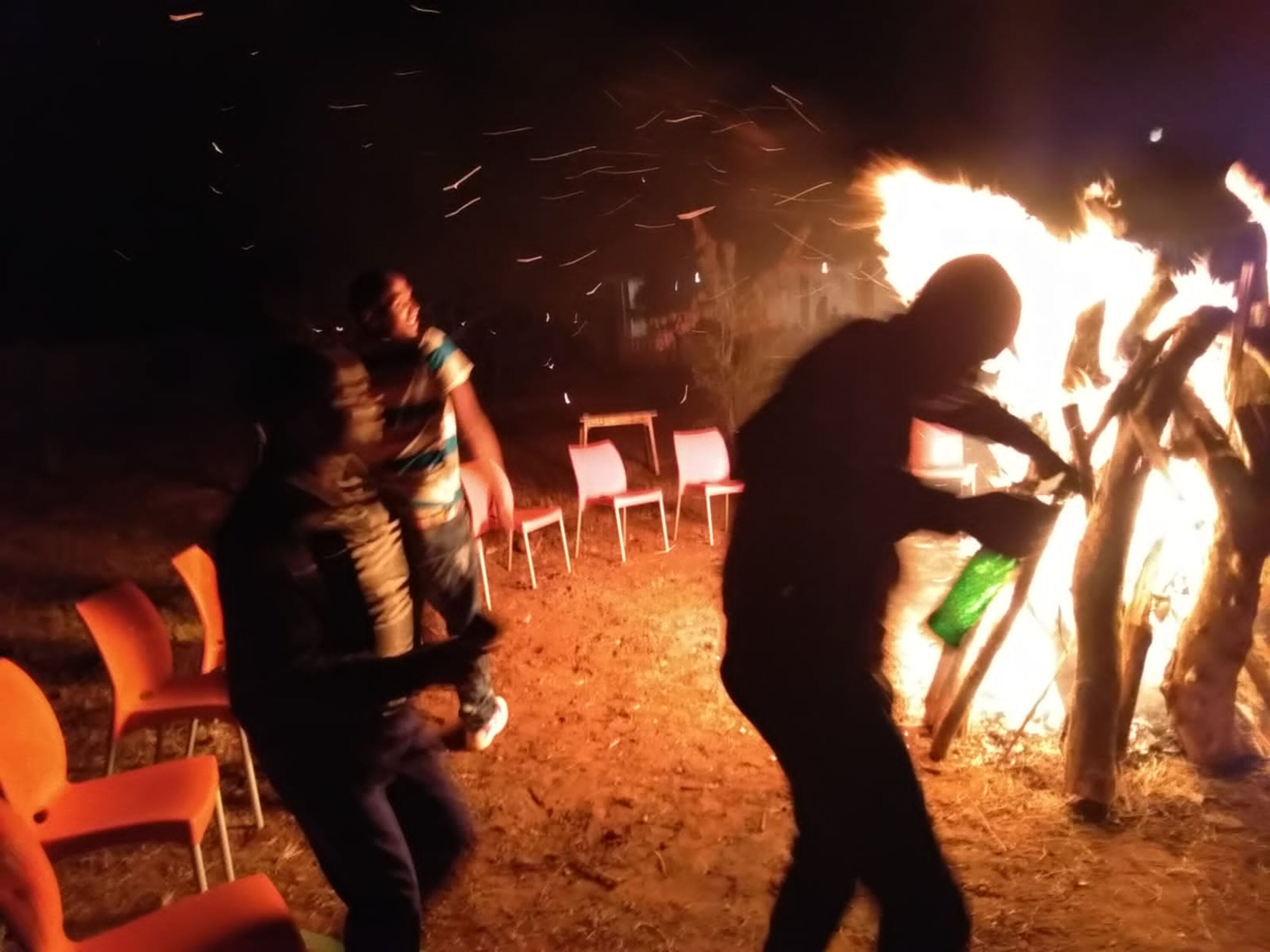 A campfire with people around it.