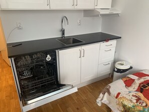 Apartment, Multiple Beds | Private kitchen | Fridge, microwave, stovetop, dishwasher