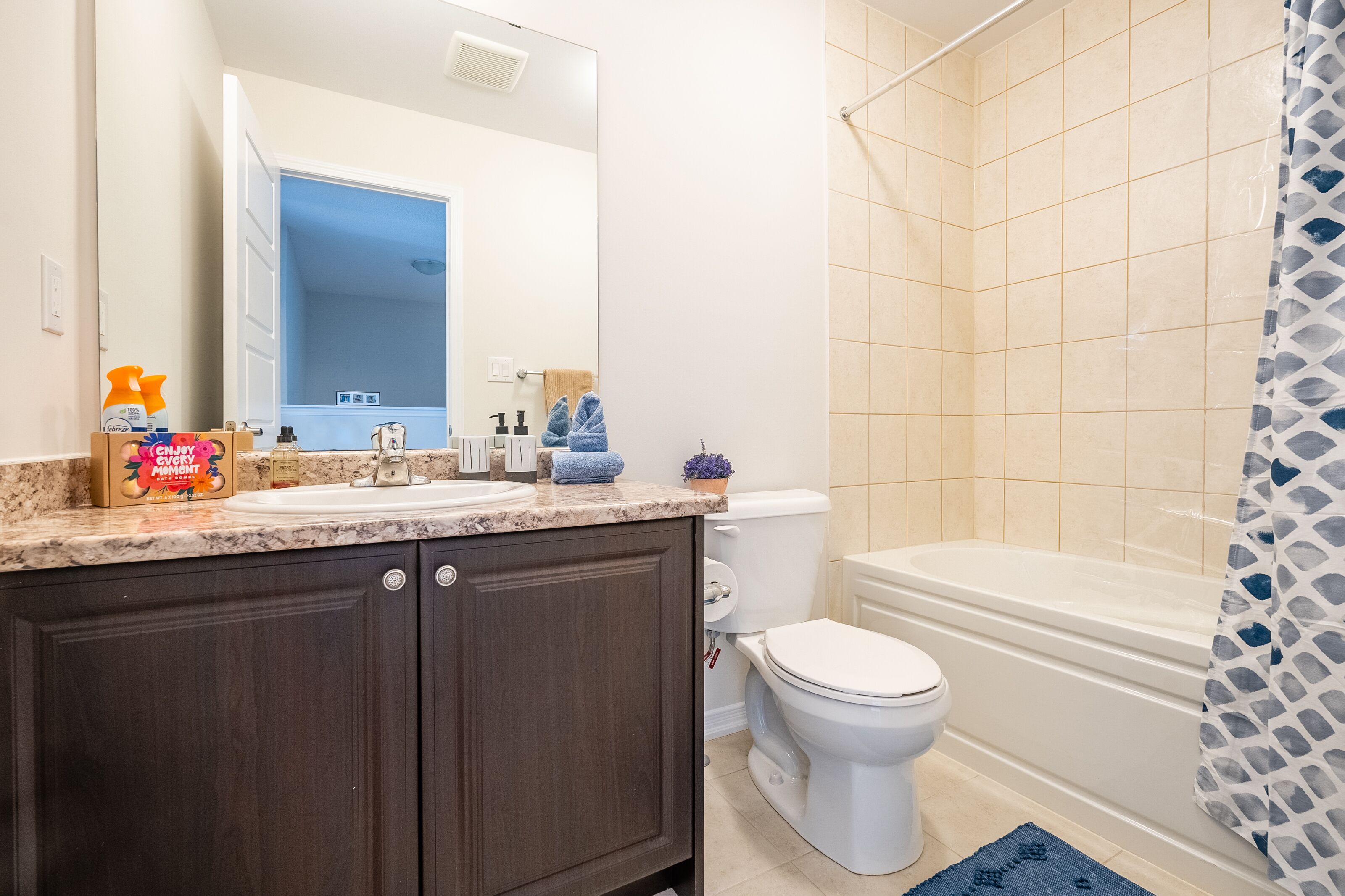 A bathroom with a sink, toilet, and bathtub.