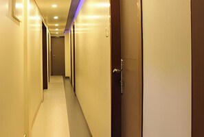 Guest rooms lead off this well-lit corridor.