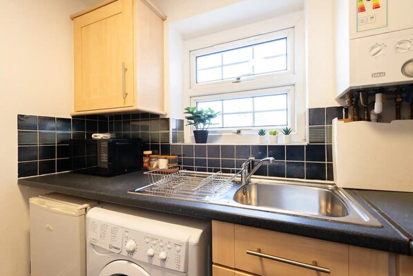 Fridge, microwave, toaster, cookware/dishes/utensils