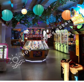 Enjoy games and entertainment in this lively arcade area with claw machines and a large game booth.