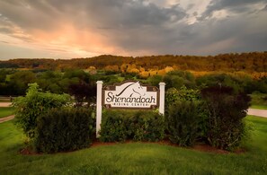 Une enseigne indiquant le centre équestre de Shenandoah, entourée d’une végétation luxuriante et d’un paysage vallonné.