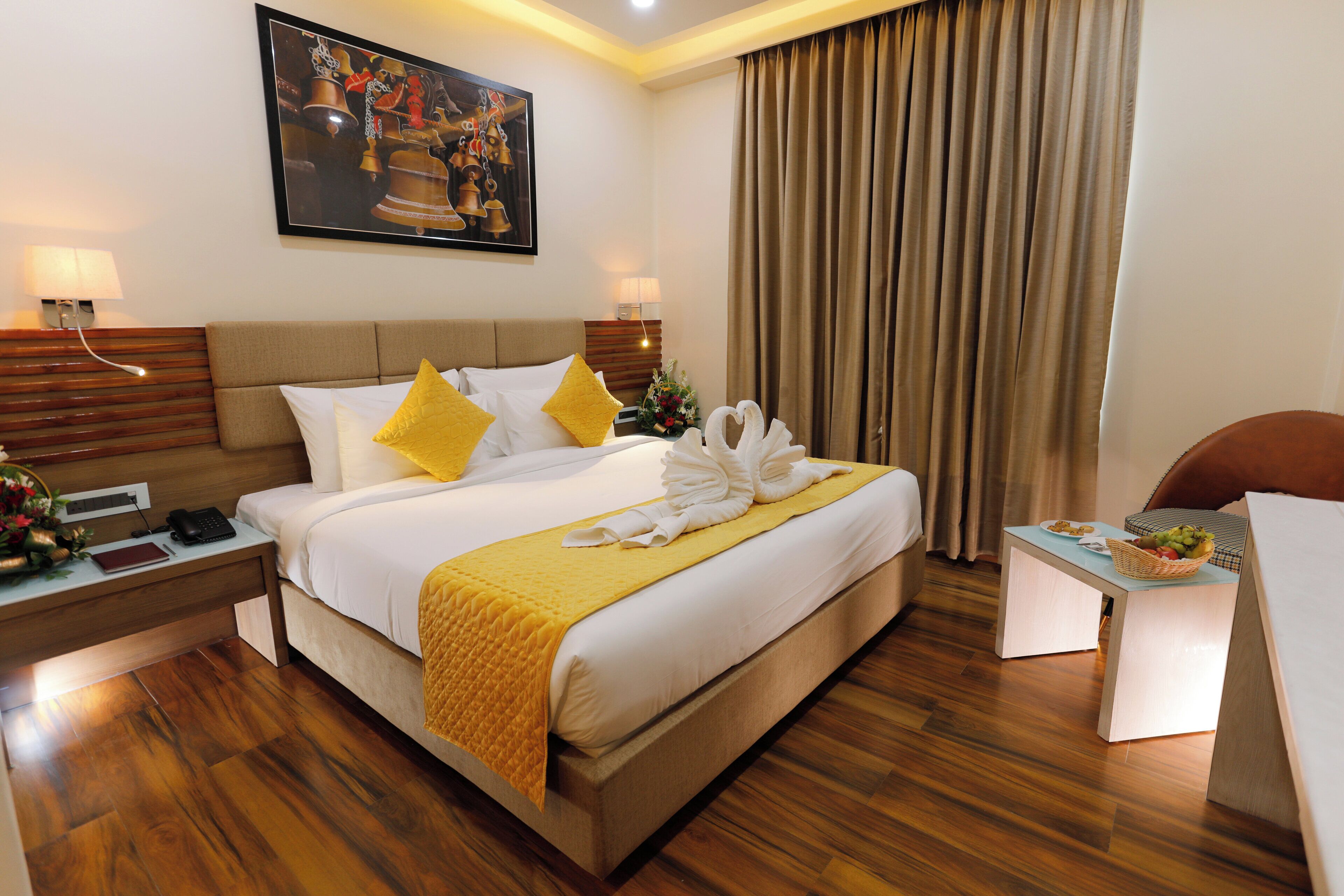 A hotel room with a bed, bedside lamps, a desk, and a chair.