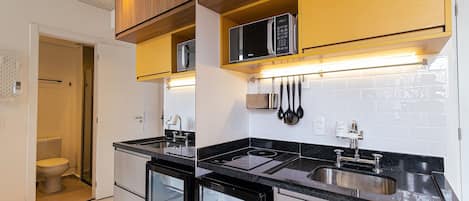 Fridge, microwave, coffee/tea maker, cookware/dishes/utensils